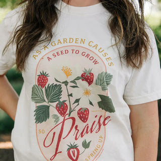 Person wearing a white t-shirt with a floral design and text.
