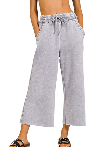 Gray wide-leg pants worn by a person on a white background