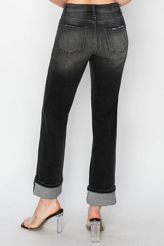 Black jeans worn by a person on a white background