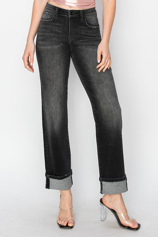 Person wearing black jeans with a white background