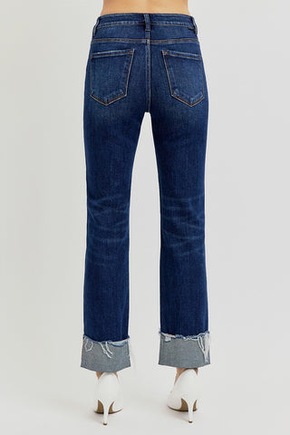 Blue jeans with cuffed hem on a white background
