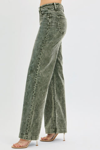 Green acid-wash jeans worn by a person on a white background