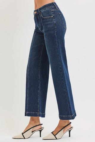 Blue jeans worn by a person on a white background