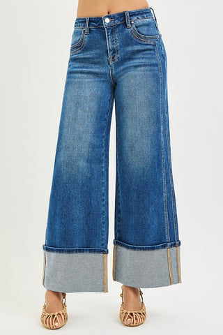 Wide-leg blue jeans with a white background