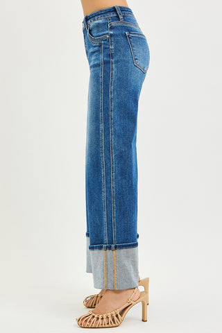 Blue jeans with a white patch on a white background