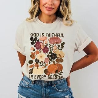 Person wearing a t-shirt with floral and pumpkin design and text.