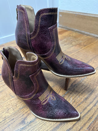 Purple ankle boots with brown block heel on a white background