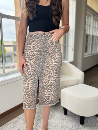 Person wearing leopard print shorts and a black top indoors.