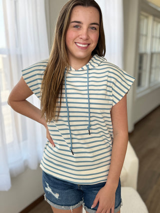 Woman wearing a striped shirt and denim shorts indoors