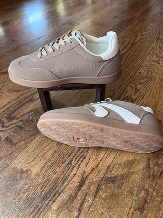 Beige sneakers on a wooden floor