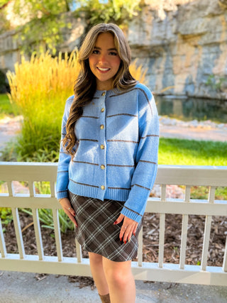 Model is wearing a blue sweater.