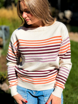 Model is wearing a striped sweater.