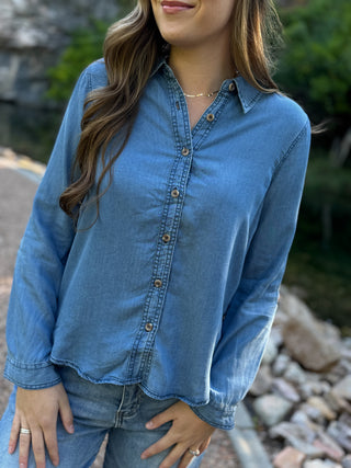 Woman in a medium wash chambray button-down shirt with jeans | V-Rae's Boutique