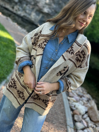 Woman in a cream Aztec horse print cardigan over a chambray shirt | V-Rae's Boutique