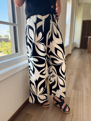 Black and white flowy pants against a white background.