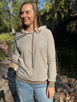 Woman in a taupe micro-striped raglan hoodie | V-Rae's Boutique