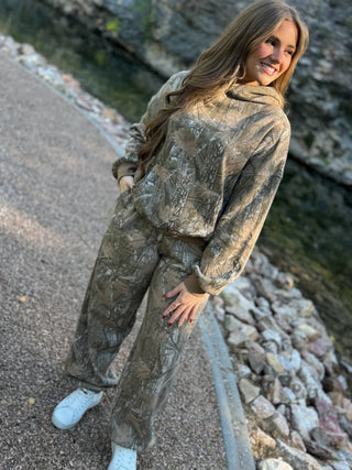 Model is wearing a camo set.