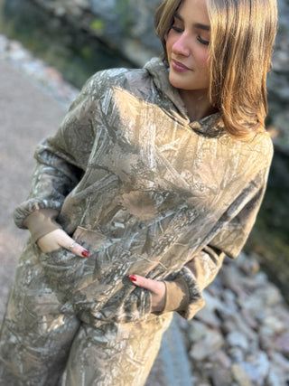 Model is wearing a camo hoodie.