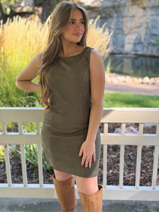 Woman in an olive faux suede sleeveless mini dress with cognac boots | V-Rae's Boutique