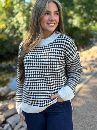 Black and white houndstooth sweater worn with dark jeans | V-Rae's Boutique