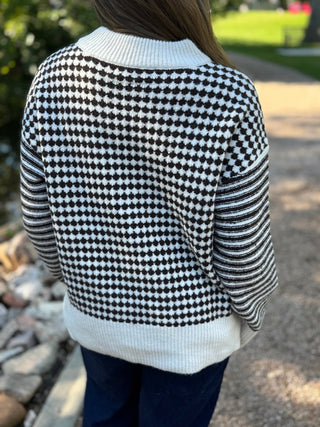 Back view of a black and white houndstooth crew neck sweater | V-Rae's Boutique