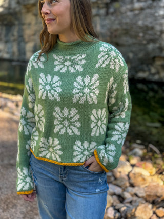 Green daisy print mock neck sweater with mustard trim, worn with jeans | V-Rae's Boutique