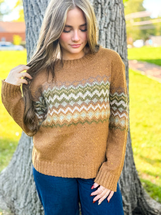 Woman in a camel fair isle chevron knit sweater with dark jeans | V-Rae's Boutique