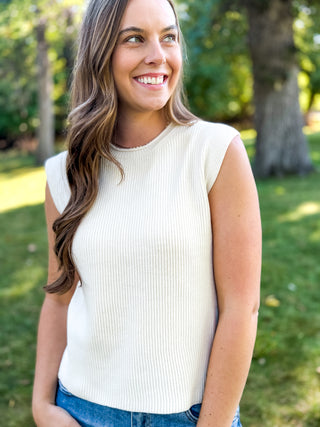 Woman in a cream dolman sleeve ribbed knit top with jeans | V-Rae's Boutique