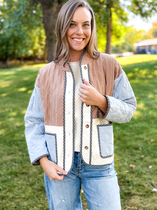 Woman in a colorblock quilted jacket with gingham trim in tan, cream and blue | V-Rae's Boutique