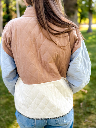 Back view of a tan, cream and blue quilted jacket with gingham trim | V-Rae's Boutique