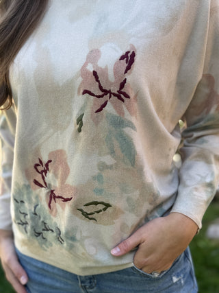 Close-up of the watercolor floral design on a cream batwing sweater | V-Rae's Boutique