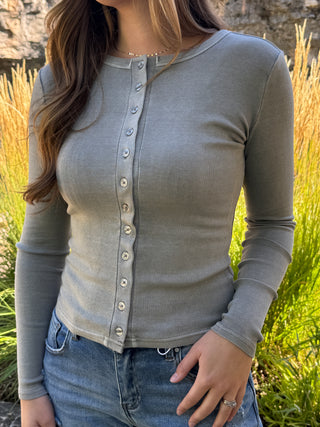 Woman in a sage gray ribbed button-front long sleeve top with jeans | V-Rae's Boutique