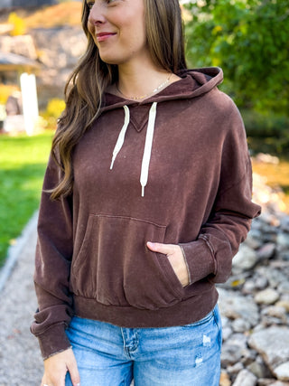 Brown vintage wash hoodie with a hand in the kangaroo pocket | V-Rae's Boutique