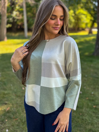 Woman in a sage, cream and taupe color-block batwing knit sweater | V-Rae's Boutique