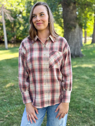 Woman in an oversized rose and cream plaid flannel shirt with jeans | V-Rae's Boutique