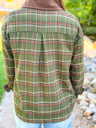 Back view of a green plaid flannel shirt with a pleated back yoke | V-Rae's Boutique