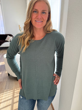 Woman wearing a green cardigan in an indoor setting