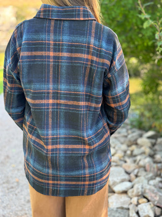 Back view of a navy and orange plaid flannel shacket | V-Rae's Boutique