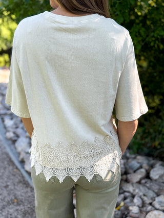 Back view of a cream top with a scalloped crochet hem | V-Rae's Boutique