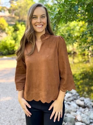 Woman in a cognac faux suede blouse with scalloped hem and bell sleeves | V-Rae's Boutique
