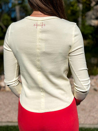Back view of a cream long sleeve ribbed henley top | V-Rae's Boutique