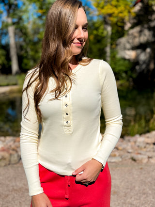 Cream long sleeve ribbed henley top styled with red pants | V-Rae's Boutique