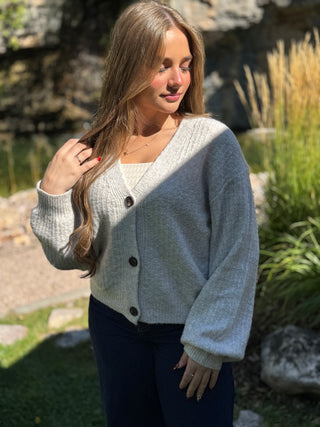Side angle of a gray balloon sleeve V-neck cardigan over a white tank | V-Rae's Boutique
