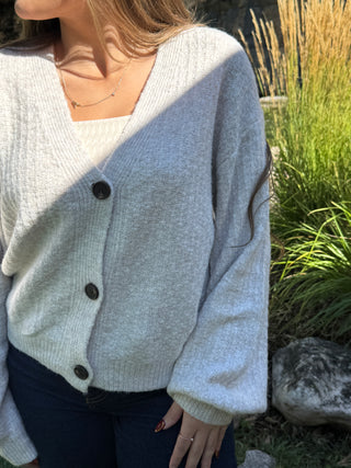 Close-up of the V-neckline, textured knit and buttons on a gray cardigan | V-Rae's Boutique