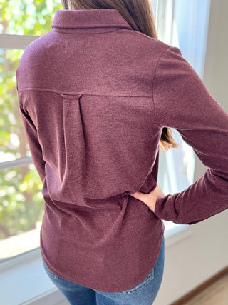 Back of lady wearing a wine flannel button up.