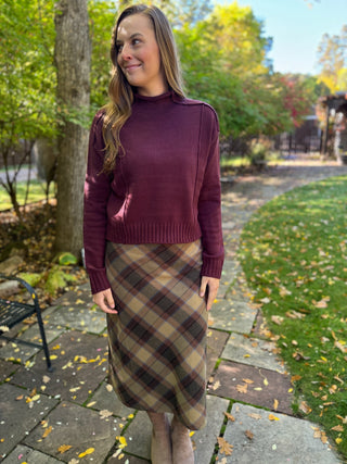 Woman in an olive plaid midi skirt with a plum sweater | V-Rae's Boutique