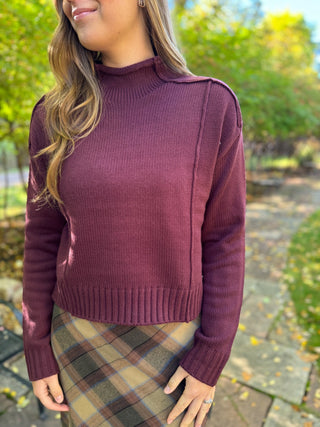 Plum mock neck cropped sweater with exposed seams and plaid skirt | V-Rae's Boutique
