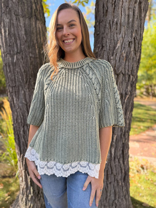 Woman in a sage cable knit sweater with white lace trim hem | V-Rae's Boutique