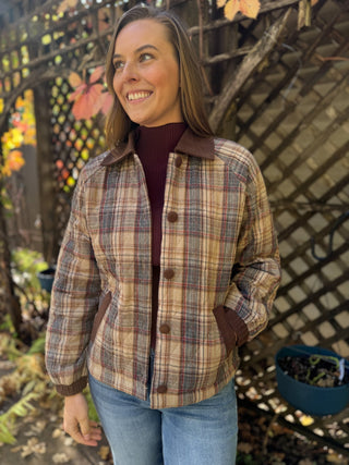 Woman in a tan plaid quilted jacket with brown corduroy collar | V-Rae's Boutique