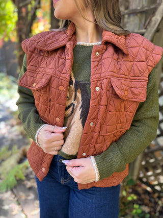 Close-up of the snap front and pockets on a rust quilted vest | V-Rae's Boutique
